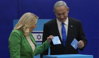 Likud party chairman Benjamin Netanyahu and his wife &#39;Sara cast their ballots during Israeli elections in Jerusalem, Tuesday, Nov. 1, 2022. (AP Photo/Maya Alerruzzo)