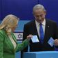Likud party chairman Benjamin Netanyahu and his wife &#39;Sara cast their ballots during Israeli elections in Jerusalem, Tuesday, Nov. 1, 2022. (AP Photo/Maya Alerruzzo)