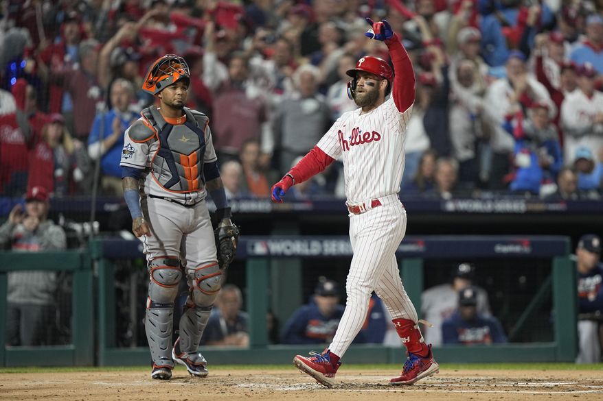 Philadelphia Phillies&#x27; Bryce Harper celebrates his two-run home run during the first inning in Game 3 of baseball&#x27;s World Series between the Houston Astros and the Philadelphia Phillies on Tuesday, Nov. 1, 2022, in Philadelphia. (AP Photo/David J. Phillip)