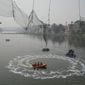 Rescuers on boats search in the Machchu river next to a cable bridge that collapsed on Sunday in Morbi town of western state Gujarat, India, Tuesday, Nov. 1, 2022. A century-old cable suspension bridge collapsed into the river Sunday evening, sending hundreds plunging in the water in one of the country&#39;s worst accidents in years. (AP Photo/Ajit Solanki)