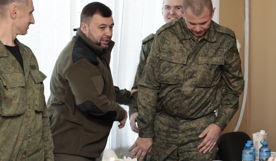 Denis Pushilin, leader of self-proclaimed Donetsk People’s Republic, second left, meets with liberated soldiers during the exchange of servicemen of the Donetsk People’s Republic who were imprisoned and the Lugansk People’s Republic, in Amvrosiivka, Donetsk People’s Republic, eastern Ukraine, Tuesday, Nov. 1, 2022. Russia and Ukraine on Saturday made an exchange of prisoners, which took place according to the formula &amp;quot;50 to 50&amp;quot;. (AP Photo/Alexei Alexandrov)