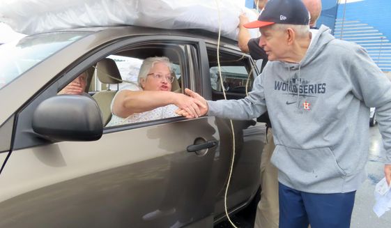 Jim &amp;quot;Mattress Mack&amp;quot; McIngvale, of Houston, shakes hands with a woman he had just given a free mattress in Atlantic City N.J., Tuesday, Nov. 1, 2022. A prolific gambler with a knack for attention-getting bets stands to win nearly $75 million if the Houston Astros win the World Series, including what sports books say would be the largest payout on a single legal sports bet in U.S. history. McIngvale has wagered a total of $10 million with numerous sports books on an Astros victory. (AP Photo/Wayne Parry)