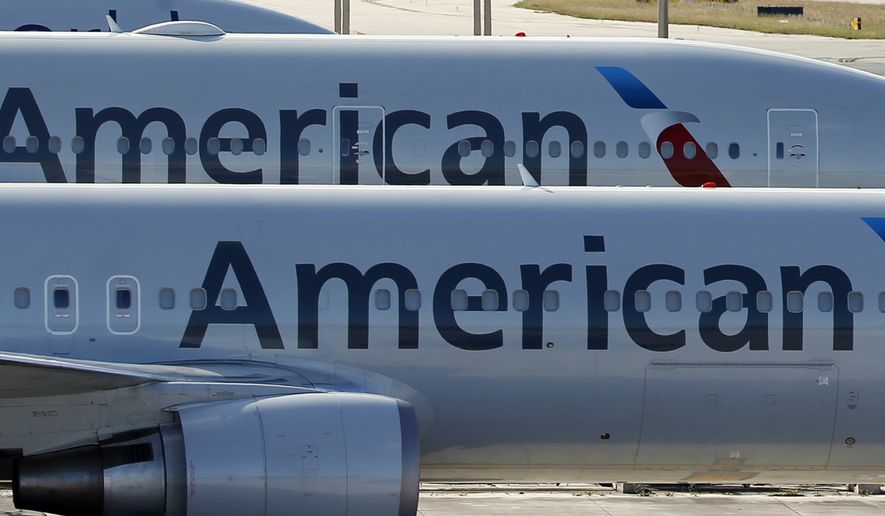 In this Monday, Nov. 6, 2017, file photo, a pair of American Airlines jets are parked on the airport apron at Miami International Airport in Miami. Pilots at another big airline are rejecting a contract offer to seek bigger pay raises. The Allied Pilots Association said Wednesday, Nov. 2, 2022, that its board voted 15-5 to reject an offer by American Airlines that included wage hikes of 19% over two years. (AP Photo/Wilfredo Lee, File)