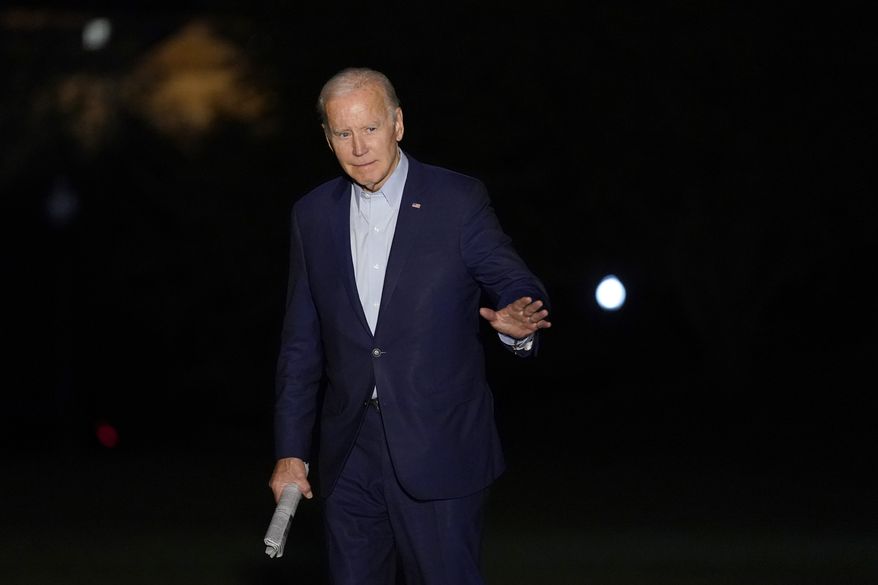 President Joe Biden waves as he walks to the White House in Washington after returning from a trip to Florida, Tuesday, Nov. 1, 2022. (AP Photo/Susan Walsh)