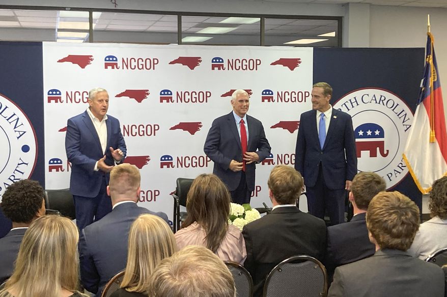 Former Vice President Mike Pence, center, joins with North Carolina Republican Party Chairman Michael Whatley, left, and U.S. Senate candidate Ted Budd for a conservation at the state GOP headquarters in Raleigh, N.C., on Wednesday. Nov. 2, 2022. Pence was in North Carolina to support Budd’s campaign. (AP Photo/Gary D. Robertson)