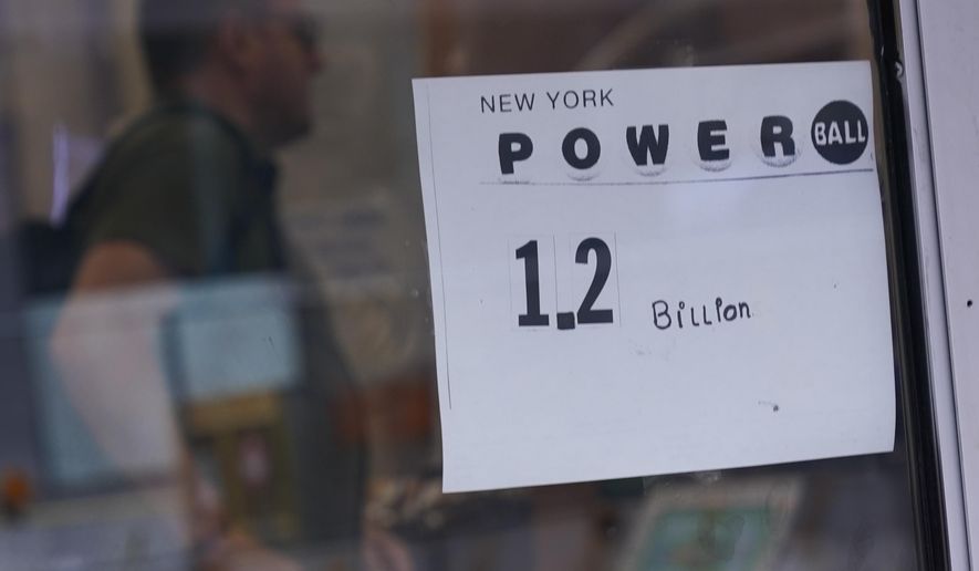A sign on a convenience store advertises the Powerball lottery in New York, Tuesday, Nov. 1, 2022. The jackpot climbed to $1.2 billion after no one matched all six numbers to win the jackpot. (AP Photo/Seth Wenig)