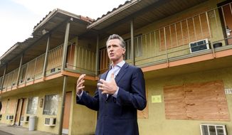California Governor Gavin Newsom speaks with reporters while touring an inn being converted to interim housing for the homeless, on Jan. 13, 2022, in Santa Clara, Calif. California Gov. Gavin Newsom said Thursday, Nov. 3, 2022, he will delay $1 billion of spending to local governments because he says they are not being aggressive enough to curb homelessness in their communities. (AP Photo/Noah Berger, File)