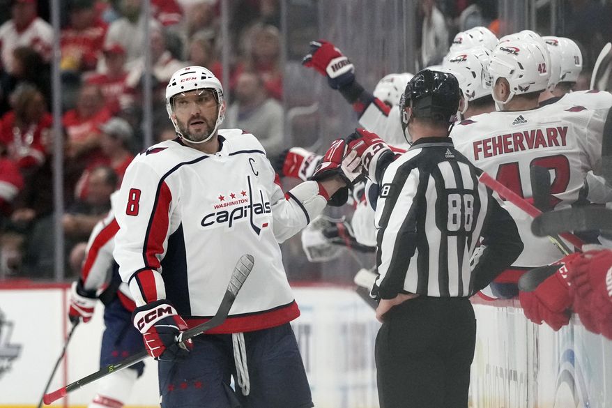 Washington Capitals left wing Alex Ovechkin greets teammates after scoring during the second period of an NHL hockey game against the Detroit Red Wings, Thursday, Nov. 3, 2022, in Detroit. (AP Photo/Carlos Osorio)