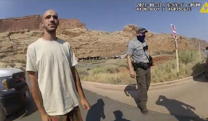 In this image taken from police body camera video provided by The Moab Police Department, Brian Laundrie talks to a police officer after police pulled over the van he was traveling in with his girlfriend, Gabrielle "Gabby" Petito, near the entrance to Arches National Park in Utah on Aug. 12, 2021. The family of Petito filed a notice of claim Monday, Aug. 8, 2022, of plans to file a wrongful death lawsuit against the tourist town of Moab, Utah, over police officers' handling of an encounter with Petito and her boyfriend weeks she was found dead in Wyoming. (The Moab Police Department via AP, File)