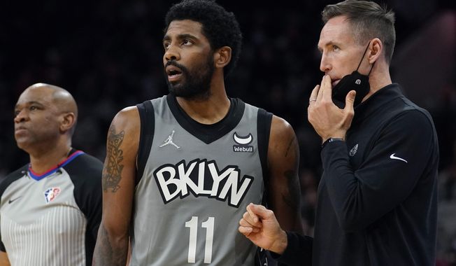 Brooklyn Nets guard Kyrie Irving (11) talks with head coach Steve Nash, right, during the first half of an NBA basketball game against the San Antonio Spurs, Friday, Jan. 21, 2022, in San Antonio. Whatever happens next in the never-ending string of Kyrie Irving developments won’t be taking up Nash’s time. (AP Photo/Eric Gay, File)