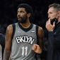 Brooklyn Nets guard Kyrie Irving (11) talks with head coach Steve Nash, right, during the first half of an NBA basketball game against the San Antonio Spurs, Friday, Jan. 21, 2022, in San Antonio. Whatever happens next in the never-ending string of Kyrie Irving developments won’t be taking up Nash’s time. (AP Photo/Eric Gay, File)