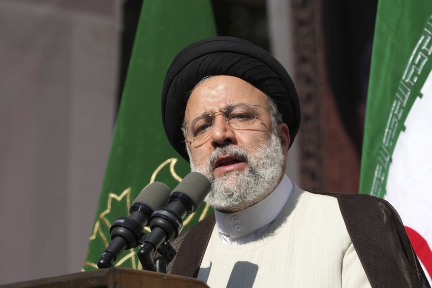 Iranian President Ebrahim Raisi addresses the crowd during an annual demonstration in front of the former U.S. Embassy in Tehran, Iran, Friday, Nov. 4, 2022. Iran on Friday marked the 1979 takeover of the U.S. Embassy in Tehran as its theocracy faces nationwide protests after the death of a 22-year-old woman earlier arrested by the country's morality police. (AP Photo/Vahid Salemi)