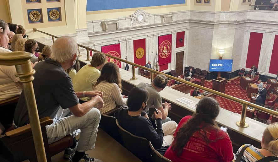 FILE - Members of the public watch the start of a West Virginia Senate hearing to discuss an abortion bill on July 29, 2022, at the state Capitol in Charleston, W.Va. West Virginia lawmakers are asking voters in the Tuesday, Nov. 8, 2022, election to give them more power to regulate public education policy and certain taxes while prohibiting state Supreme Court intervention in the Legislature's impeachment trials. (AP Photo/John Raby, File)