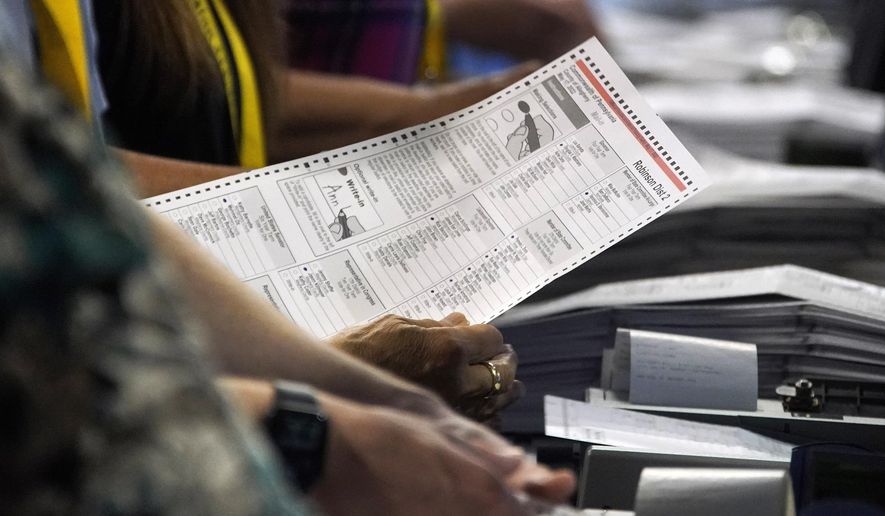Election workers perform a recount of ballots from the recent Pennsylvania primary election, Wednesday, June 1, 2022, at the Allegheny County Election Division warehouse on the Northside of Pittsburgh. (AP Photo/Gene J. Puskar) **FILE**