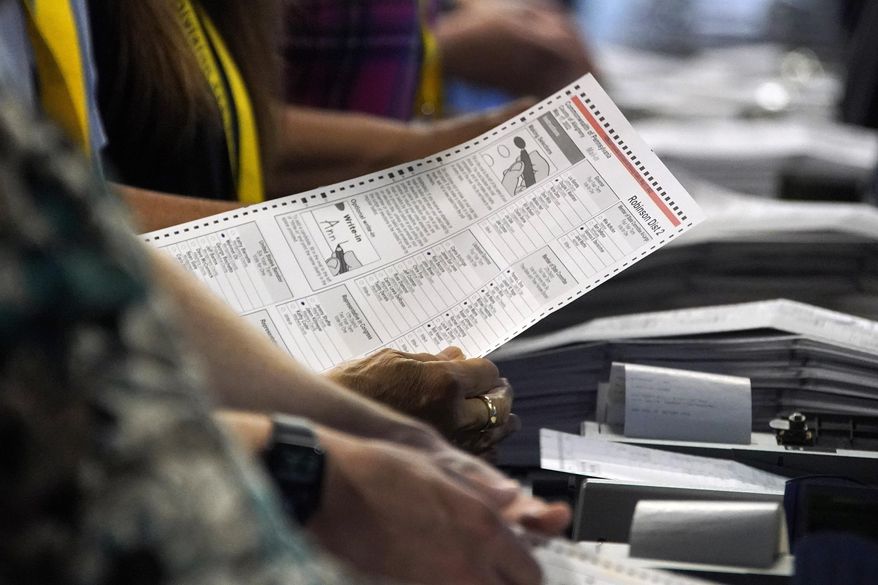 Election workers perform a recount of ballots from the recent Pennsylvania primary election, Wednesday, June 1, 2022, at the Allegheny County Election Division warehouse on the Northside of Pittsburgh. (AP Photo/Gene J. Puskar) **FILE**