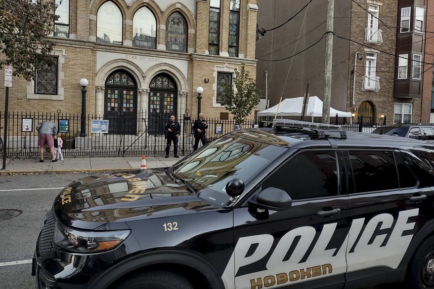 Hoboken Police officers stand watch outside the United Synagogue of Hoboken, Thursday, Nov. 3, 2022, in Hoboken, N.J. Investigators in a New Jersey town are searching for the man who threw a Molotov cocktail at a synagogue (not pictured) on Sunday, Jan. 29, an incident that coincides with fears about rising antisemitism. AP Photo/Ryan Kryska)