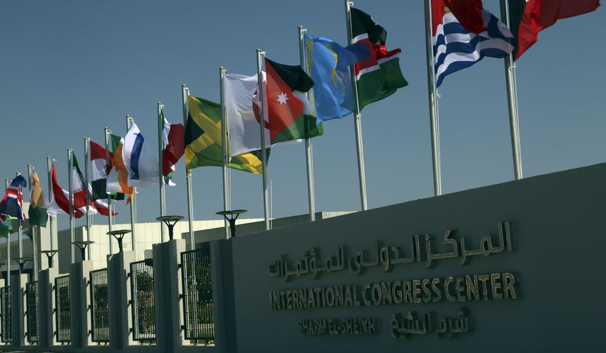 Flags from countries participating in this year’s United Nations global summit on climate change, known as COP27, hang outside the conference center, in Sharm el-Sheikh, South Sinai, Egypt, Wednesday, Nov. 2, 2022. As this year’s United Nations climate summit approaches, Egypt’s government is touting its efforts to make Sharm el-Sheikh a more eco-friendly tourist destination. (AP Photo/Thomas Hartwell)