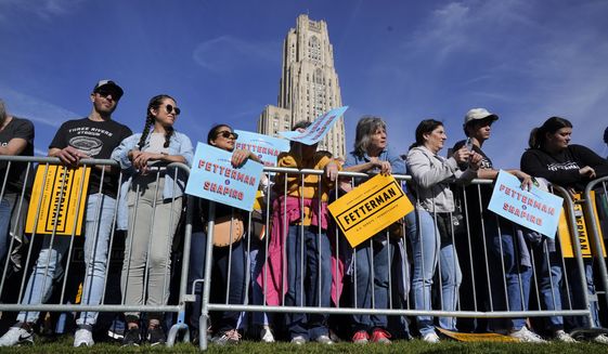 A crowd gathers for a rally in support of Pennsylvania Lt. Gov. John Fetterman, a Democratic candidate for U.S. Senate, with former President Barrack Obama in Pittsburgh, Saturday, Nov. 5, 2022. The Cathedral of Learning on the University of Pittsburgh campus is seen in the background. (AP Photo/Gene J. Puskar)
