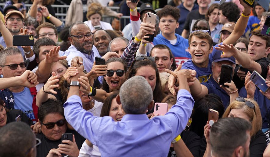 Former President Barrack Obama, foreground center, greets the crowd after speaking during a campaign rally in support of Pennsylvania Lt. Gov. John Fetterman, a Democratic candidate for U.S. Senate, in Pittsburgh, Saturday, Nov. 5, 2022. (AP Photo/Gene J. Puskar)