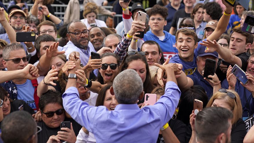 Former President Barrack Obama, foreground center, greets the crowd after speaking during a campaign rally in support of Pennsylvania Lt. Gov. John Fetterman, a Democratic candidate for U.S. Senate, in Pittsburgh, Saturday, Nov. 5, 2022. (AP Photo/Gene J. Puskar)