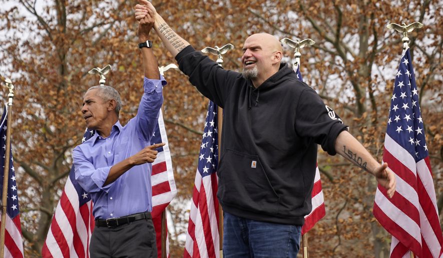 Former President Barrack Obama, left, finishes his remarks and welcomes Pennsylvania Lt. Gov. John Fetterman, a Democratic candidate for U.S. Senate, to the stage during a campaign rally in Pittsburgh, Saturday, Nov. 5, 2022. (AP Photo/Gene J. Puskar)