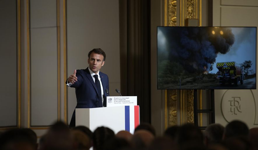 French President Emmanuel Macron delivers a speech in front of people involved in fighting wildfires last summer, Friday, Oct. 28, 2022 at the Elysee Palace in Paris. Emmanuel Macron meets firefighters, rescuers, and volunteers who battled brutal summer blazes (AP Photo/Christophe Ena, Pool)