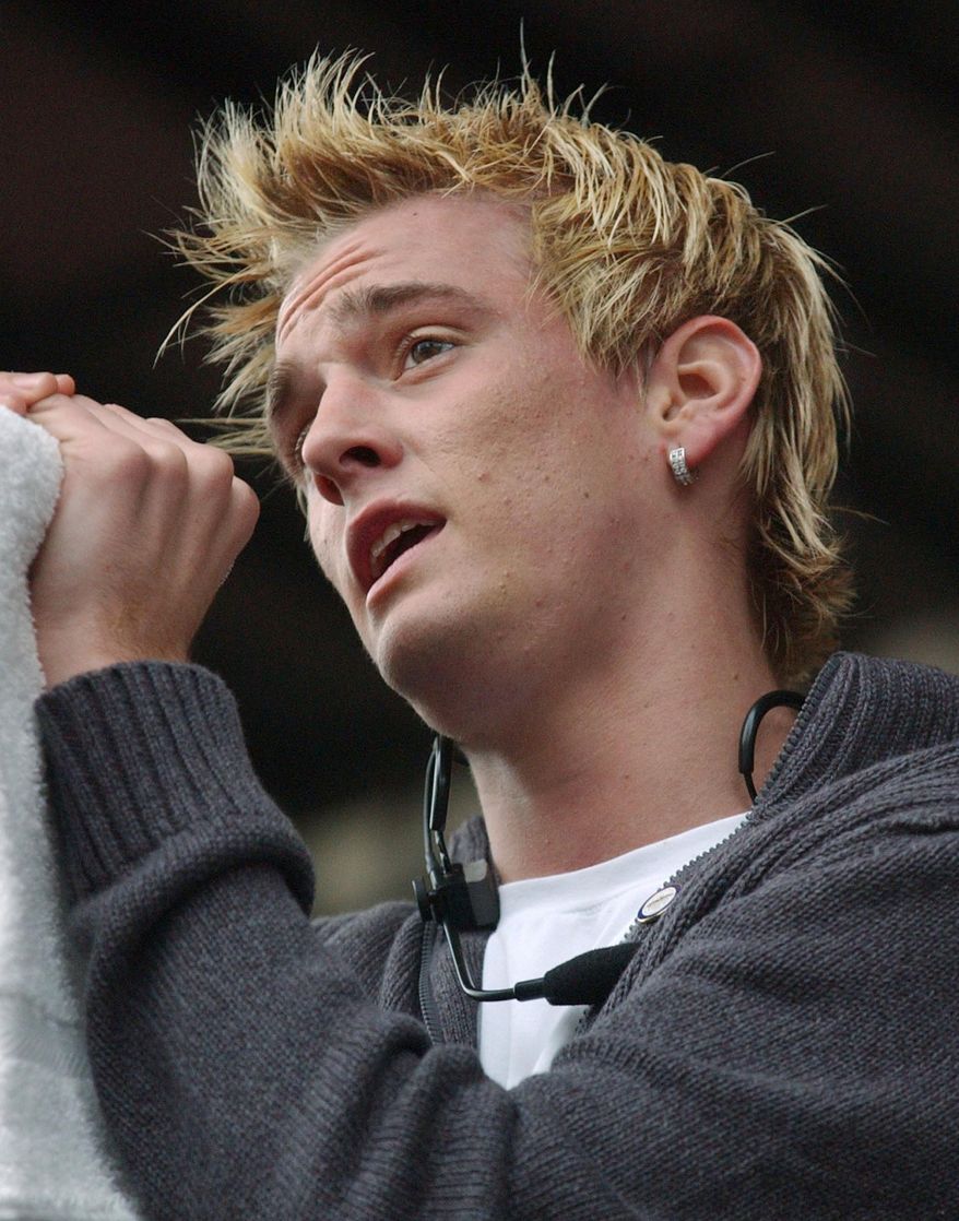 Singer Aaron Carter sings to a crowd during a First Night celebration at Government Center, on Dec. 31, 2004, in Boston. Carter, the singer-rapper who began performing as a child and had hit albums starting in his teen years, was found dead Saturday, Nov. 5, 2022, at his home in Southern California. He was 34. (AP Photo/Lisa Poole, File)