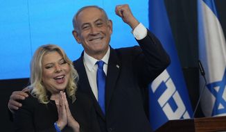 Former Israeli Prime Minister and the head of Likud party, Benjamin Netanyahu and his wife Sara gesture after first exit poll results for the Israeli Parliamentary election at his party&#x27;s headquarters in Jerusalem, Wednesday, Nov. 2, 2022. (AP Photo/Tsafrir Abayov)