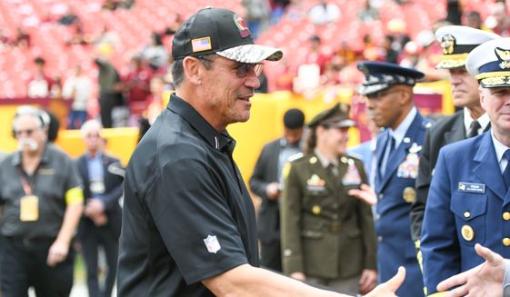 Washington Commanders Head Coach Ron Rivera on the field greeting members of the military before a game against the Minnesota Vikings at FedEx Field in Landover, MD, November 6, 2022. (Photo by Billy Sabatini) **FILE**