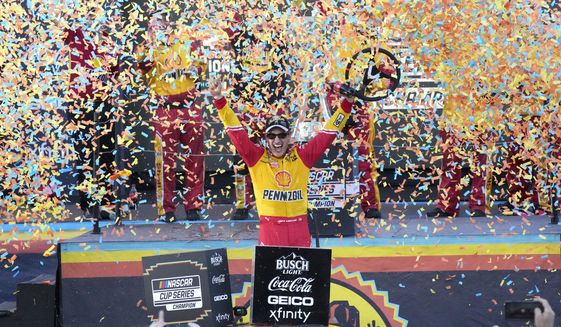 Joey Logano celebrates after winning a NASCAR Cup Series auto race and championship Sunday, Nov. 6, 2022, in Avondale, Ariz. (AP Photo/Rick Scuteri)