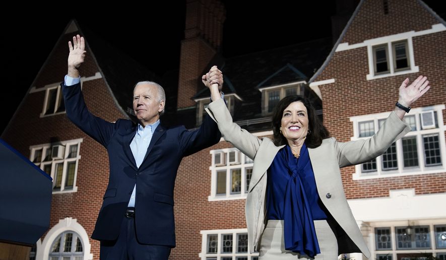 President Joe Biden holds hands with New York Gov. Kathy Hochul as they wave to the crowd after speaking at a campaign event Sunday, Nov. 6, 2022, at Sarah Lawrence College in Yonkers, N.Y. (AP Photo/Patrick Semansky)