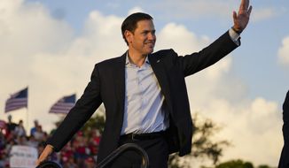 Sen. Marco Rubio, R-Fla., waves after speaking with former President Donald Trump on stage at a campaign rally at the Miami-Dade County Fair and Exposition on Sunday, Nov. 6, 2022, in Miami. (AP Photo/Rebecca Blackwell)