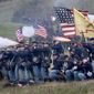 Union troops fire upon advancing Confederate troops during a reenactment of the Civil War Battle of Cedar Creek on Oct. 18, 2015, at the Cedar Creek battlefield just south of Middletown, Va. A federal trial for a former Civil War re-enactor accused of planting a pipe bomb at a Virginia battlefield in 2017 and threatening to disrupt other events has been set for 2023. (Ginger Perry/The Winchester Star via AP, File)