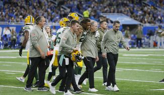 Green Bay Packers cornerback Eric Stokes (21) is helped off the field during the first half of an NFL football game against the Detroit Lions, Sunday, Nov. 6, 2022, in Detroit. (AP Photo/Duane Burleson)