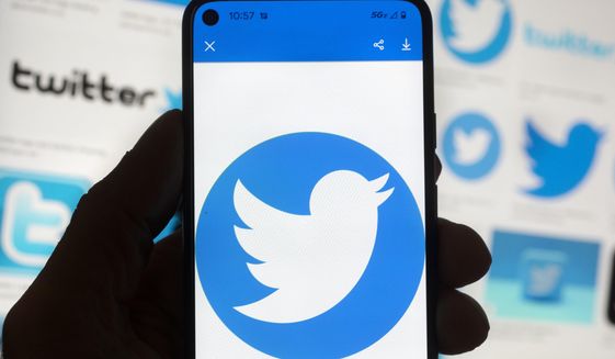The Twitter logo is seen on a cell phone, Friday, Oct. 14, 2022, in Boston. (AP Photo/Michael Dwyer) ** FILE **
