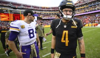 Washington Commanders quarterback Taylor Heinicke (4) walks away after speaking with Minnesota Vikings quarterback Kirk Cousins (8) on the field at the end of their NFL football game, Sunday, Nov. 6, 2022, in Landover, Md. Vikings won 20-17. (AP Photo/Nick Wass)