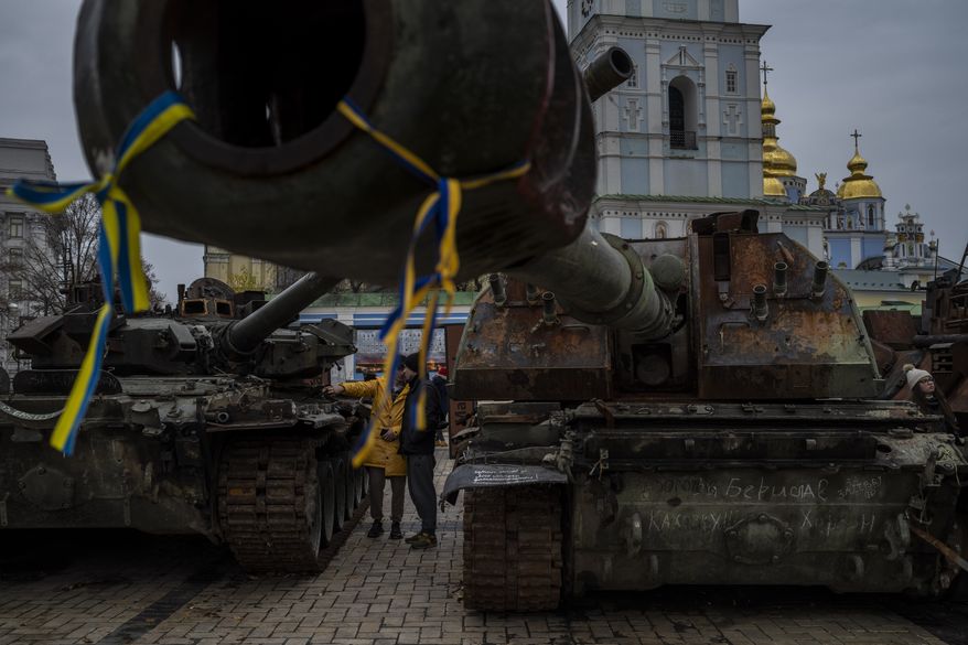 Pedestrians stand in front of a display of destroyed Russian tanks and armoured vehicles in downtown Kyiv, Ukraine, Monday, Nov. 7, 2022. (AP Photo/Bernat Armangue)