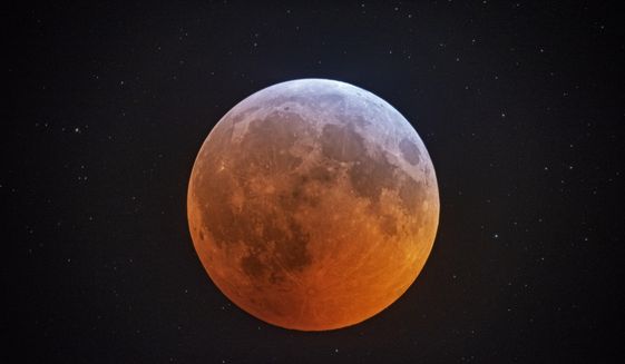 In this photo made with a 12-1/2 inch telescope and provided by Johnny Horne, the totally eclipsed moon glows with a reddish color against the background stars over Stedman, N.C., on Monday, Jan. 21, 2019.This full moon is also sometimes known as the wolf moon or great spirit moon. (Johnny Horne via AP)