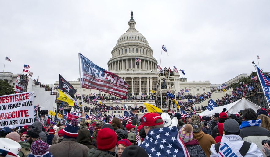 Rioters loyal to President Donald Trump rally at the U.S. Capitol in Washington on Jan. 6, 2021.  Samuel Christopher Montoya, a Texas man described as a video editor for the conspiracy theory-promoting Infowars website, pleaded guilty on Monday, Nov. 7, 2022, to storming the U.S. Capitol, where he captured footage of the scene where a police officer fatally shot a California woman who joined the mob&#x27;s attack. (AP Photo/Jose Luis Magana, File)
