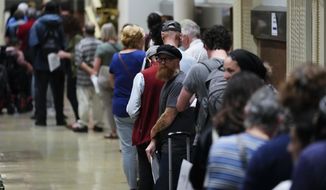 Voters wait in line to make a correction to their ballots for the midterm elections at City Hall in Philadelphia, Monday, Nov. 7, 2022. (AP Photo/Matt Rourke)