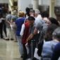 Voters wait in line to make a correction to their ballots for the midterm elections at City Hall in Philadelphia, Monday, Nov. 7, 2022. (AP Photo/Matt Rourke)