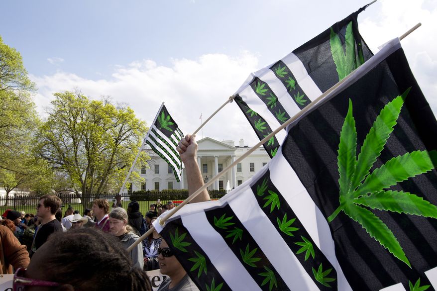A demonstrator waves a flag with marijuana leaves depicted on it during a protest calling for the legalization of marijuana, outside of the White House on April 2, 2016, in Washington. (AP Photo/Jose Luis Magana) **FILE**