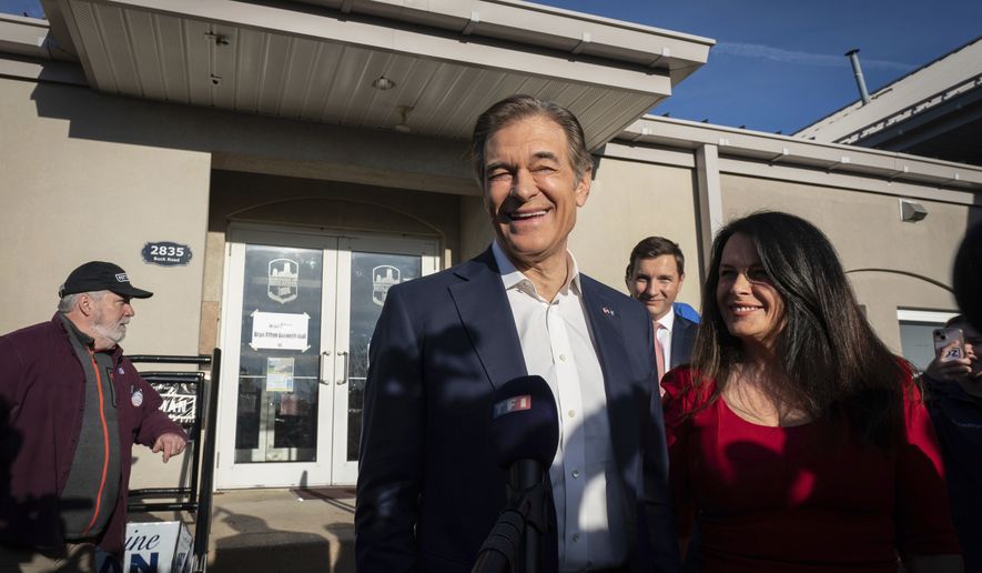 Dr. Mehmet Oz and his wife Lisa Oz exit Bryn Athyn Borough Hall after voting in Huntingdon Valley, Pa., Tuesday, Nov. 8, 2022. (Jessica Griffin/The Philadelphia Inquirer via AP)