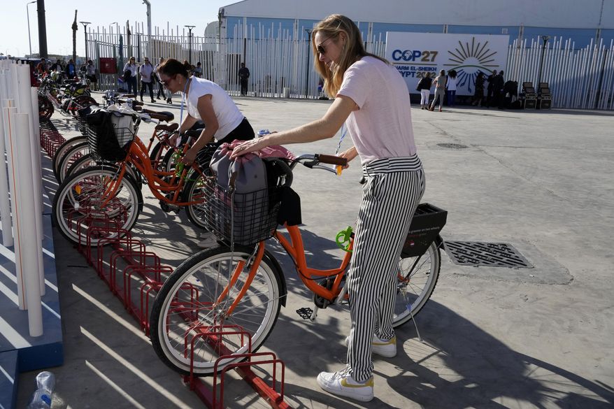 A member of the Dutch delegation parks a bicycle after arriving at the COP27 U.N. Climate Summit, Tuesday, Nov. 8, 2022, in Sharm el-Sheikh, Egypt. (AP Photo/Peter Dejong)