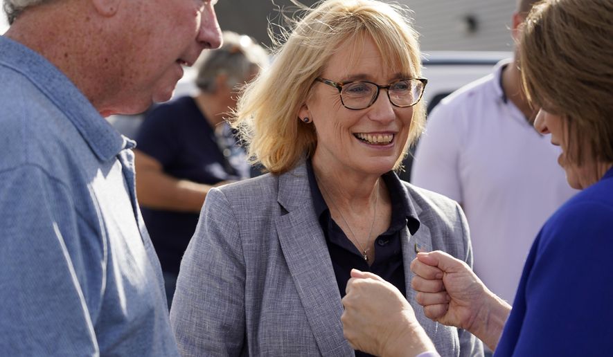 Sen. Maggie Hassan, D-N.H., smiles as she talks with Sen. Amy Klobuchar, D-Minn., following a canvass kickoff event, Sunday, Nov. 6, 2022, in Exeter, N.H. (AP Photo/Mary Schwalm)