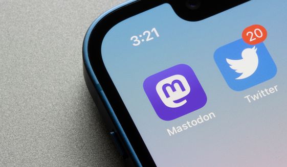 Mastodon and Twitter app icons are seen on an iPhone in Portland, Ore. on Nov 7, 2022. Mastodon, a decentralized social media platform, is rapidly gaining users after Elon Musk&#39;s Twitter takeover. File photo credit: Tada Images via Shutterstock.