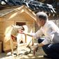 In this photo provided on Oct. 2018, by South Korea Presidential Blue House, South Korean President Moon Jae-in touches a white Pungsan dog, named Gomi, from North Korea, in Seoul, South Korea. (South Korea Presidential Blue House via AP, File)