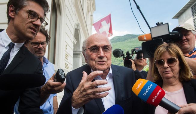 Former FIFA president Sepp Blatter is surrounded by the media as he leaves the Swiss Federal Criminal Court in Bellinzona, Switzerland, Wednesday, June 8, 2022. Blatter said on Tuesday, Nov. 8, 2022, that picking Qatar to host the World Cup was a mistake 12 years ago. (Alessandro Crinari/Keystone via AP, File) **FILE**