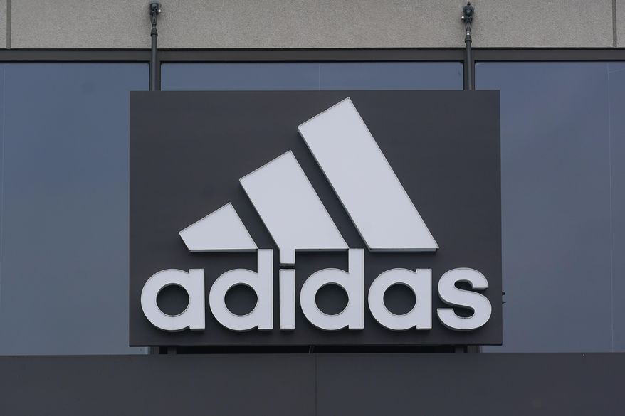A sign is displayed in front of an Adidas retail store in Paramus, N.J., Tuesday, Oct. 25, 2022. Adidas has ended its partnership with the rapper formerly known as Kanye West over his offensive and antisemitic remarks, the latest company to cut ties with Ye and a decision that the German sportswear company said would hit its bottom line. (AP Photo/Seth Wenig) ** FILE **