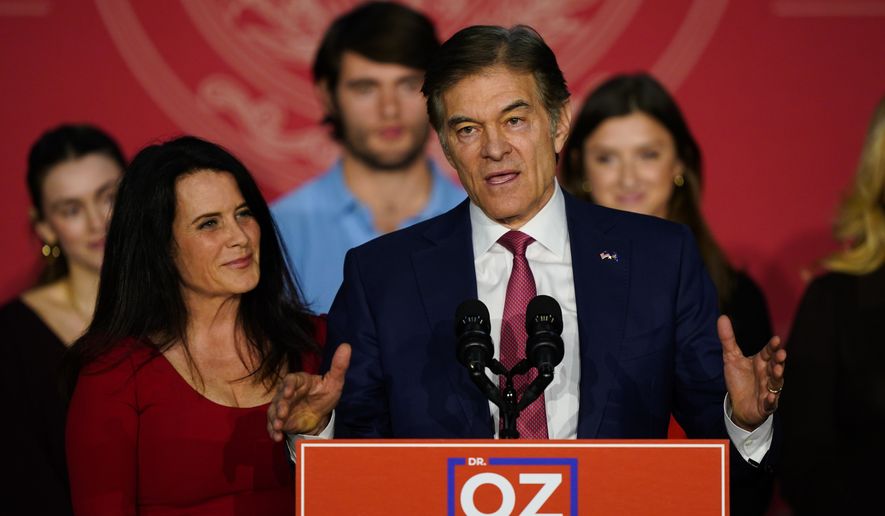 Mehmet Oz, the Republican candidate for U.S. Senate in Pennsylvania, speaks to supporters at an election night rally in Newtown, Pa., Tuesday, Nov. 8, 2022, as his wife Lisa listens. (AP Photo/Matt Rourke)